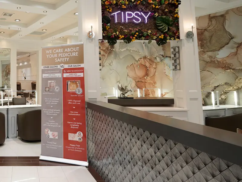 The reception counter with its quilted front and neon Tipsy sign