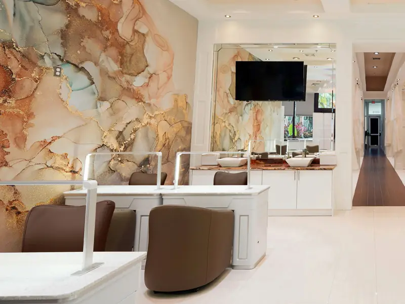 Manicure stations and the mural wall seen from the salon entry